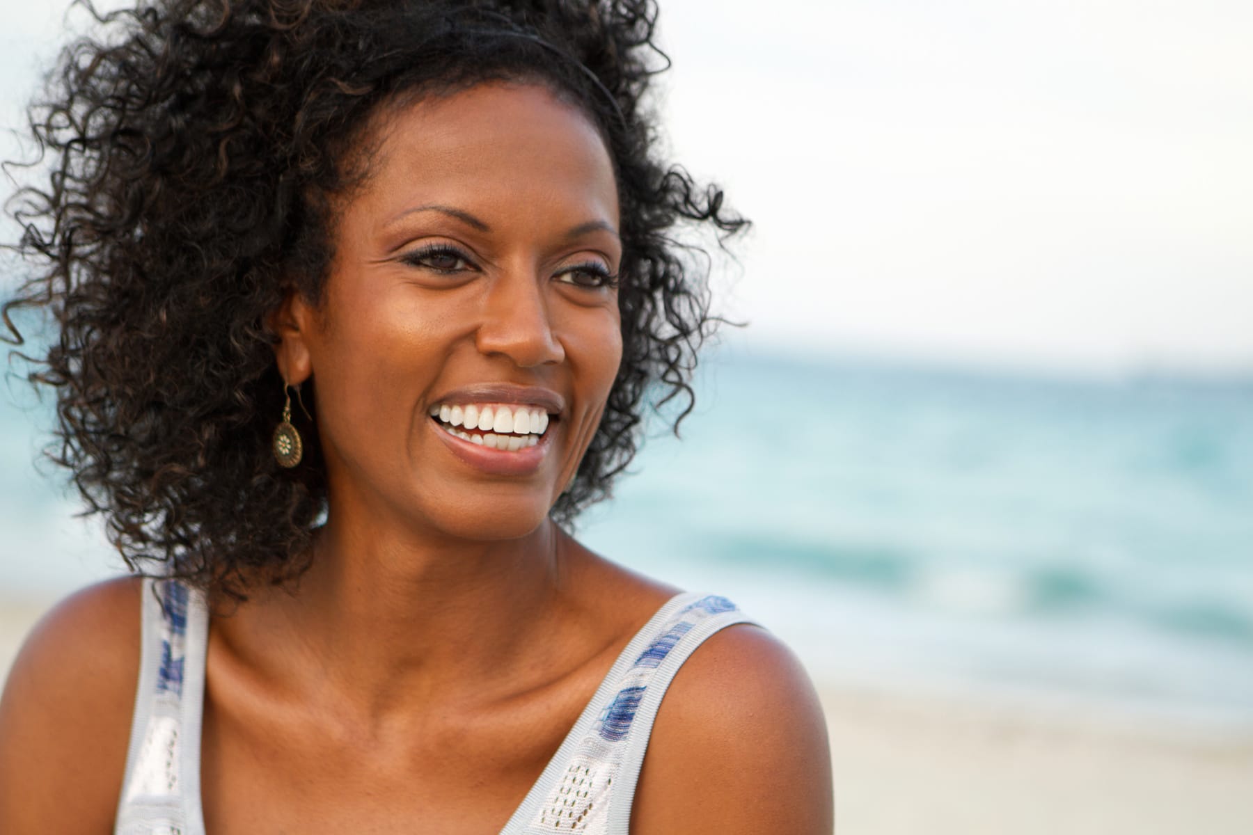 Beautiful mature woman smiling at the beach